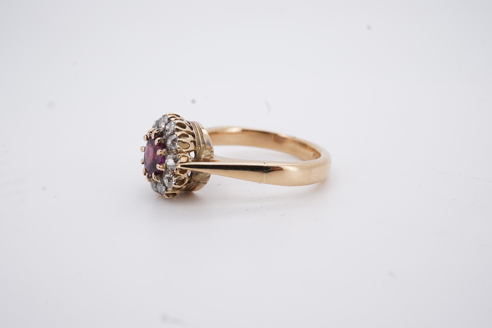 A George V 18ct gold, ruby and diamond set circular cluster ring, size M, gross weight 5 grams.